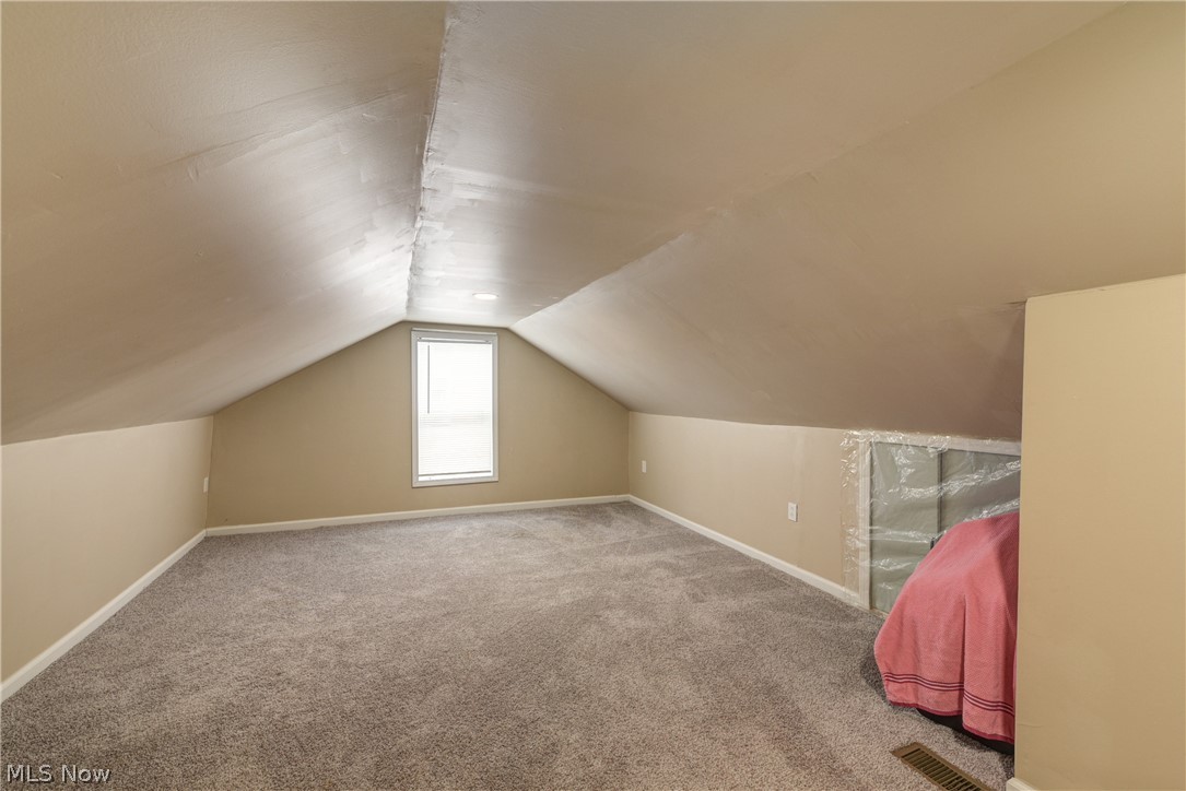 3735 Highland Road Cleveland, OH 44111 - Photo 27 of 35 Additional living space featuring carpet floors and vaulted ceiling