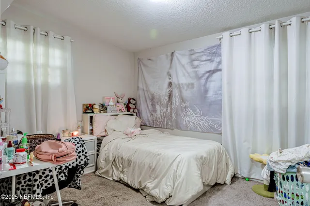 a bedroom with a bed and a table