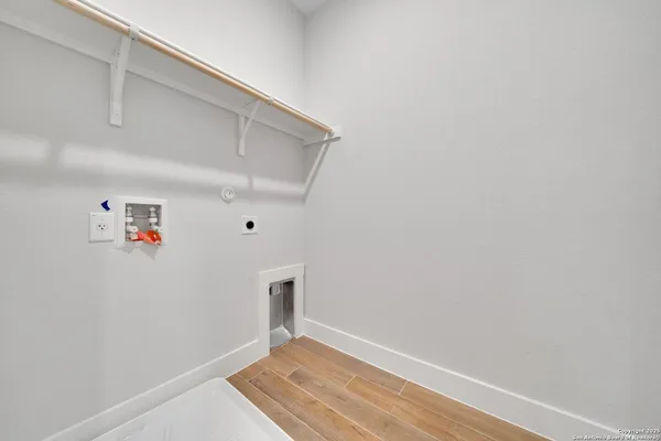 an empty room with ceiling fan and window