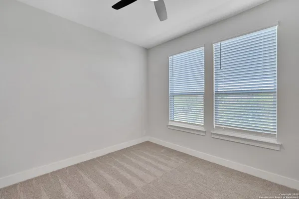 an empty room with ceiling fan