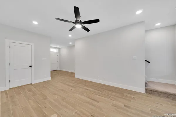 a view of a big room with wooden floor closet and windows