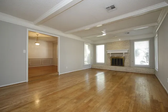 wooden floor in an empty room with a window