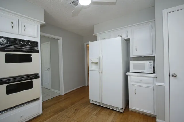 a white refrigerator freezer sitting inside of a kitchen