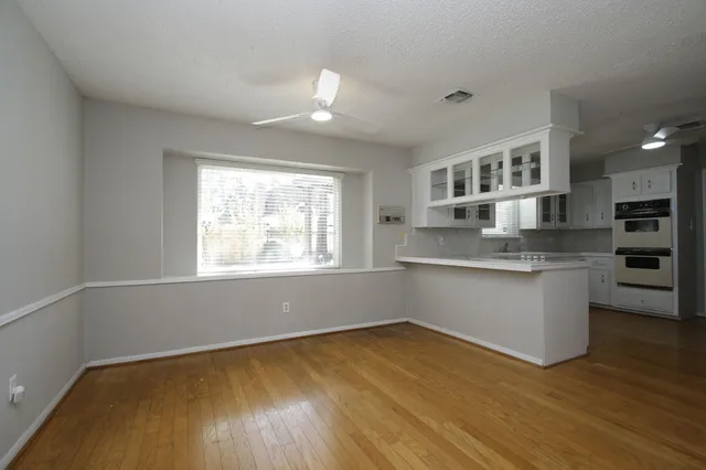 a kitchen with a wooden floor and window