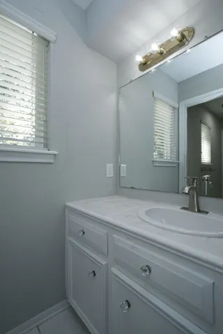 a bathroom with a sink and mirror