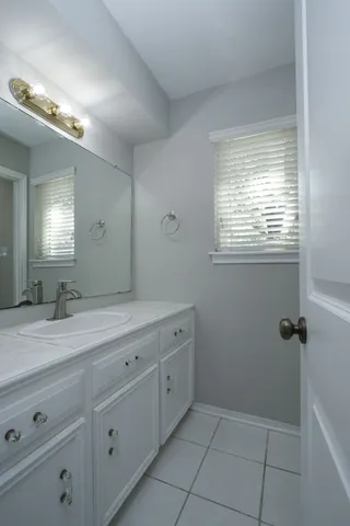 a bathroom with a granite countertop sink a mirror and a