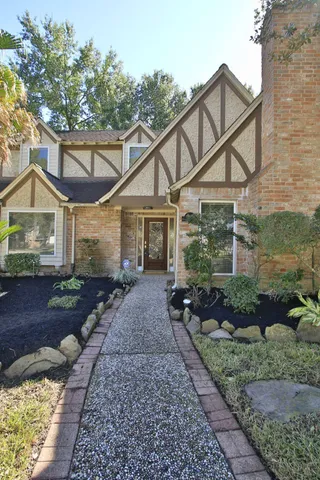 a front view of a house with garden