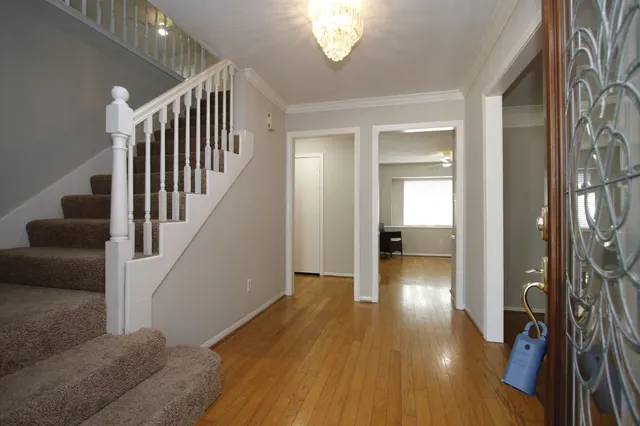 a view of entryway and hall with wooden floor
