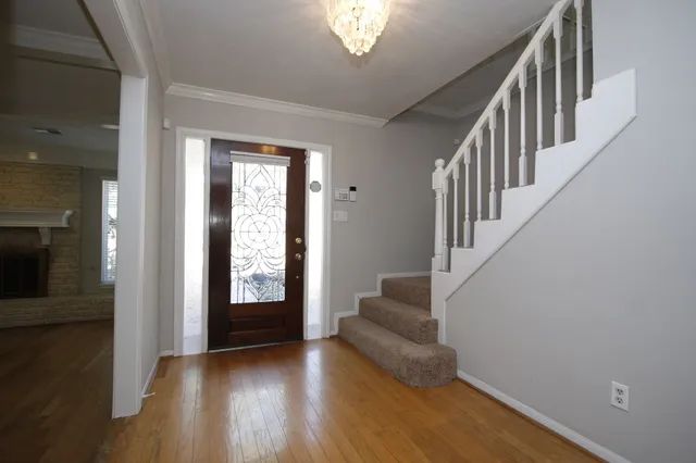 a view of entryway and hall with wooden floor