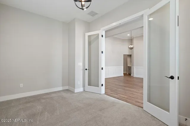 a large kitchen with stainless steel appliances granite countertop a sink a stove a refrigerator and wooden floor