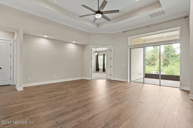 a view of a livingroom with a ceiling fan and window