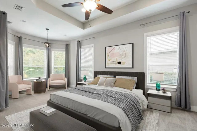 an empty room with windows and a ceiling fan