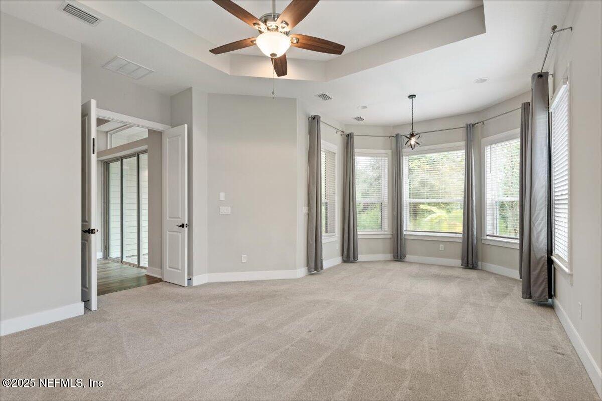 141 Topside Dr. St. Johns, FL 32259 - Photo 32 of 71 a view of a big room with chandelier fan and windows