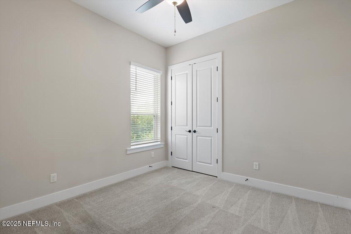 141 Topside Dr. St. Johns, FL 32259 - Photo 43 of 71 an empty room with windows and a ceiling fan
