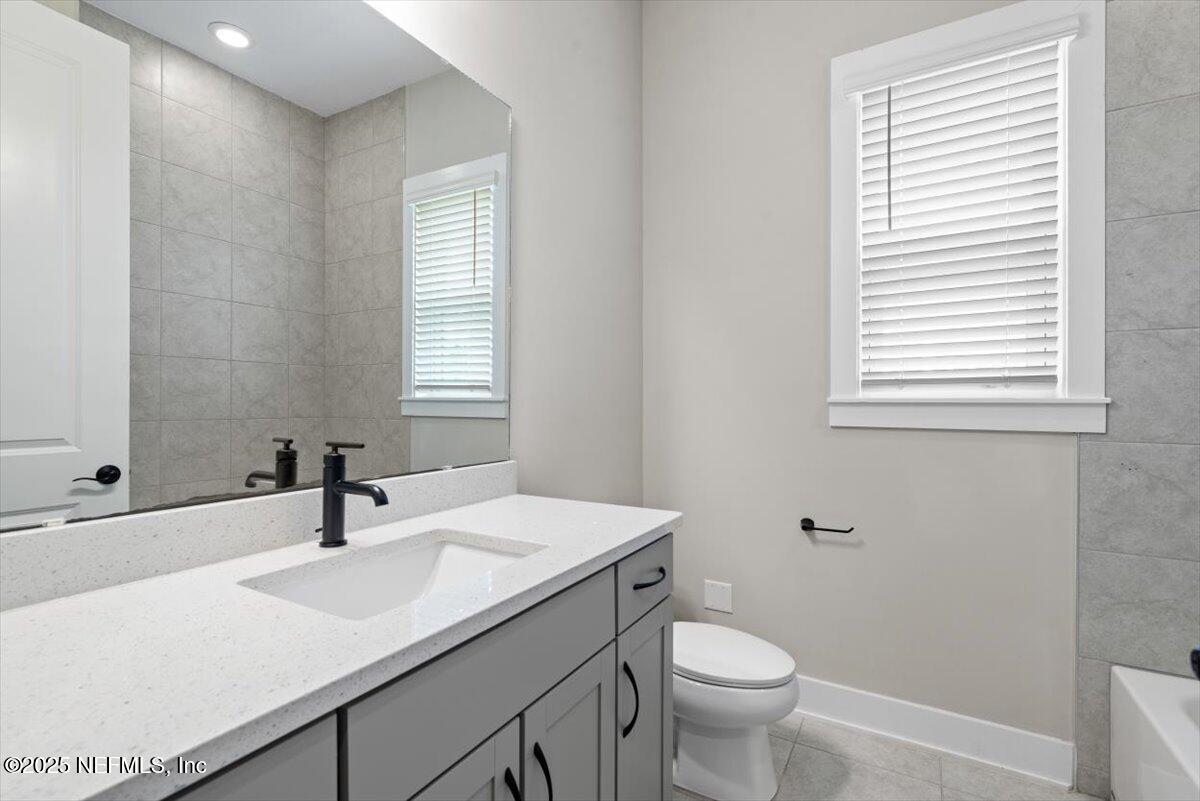 141 Topside Dr. St. Johns, FL 32259 - Photo 44 of 71 a bathroom with a sink a toilet and a mirror