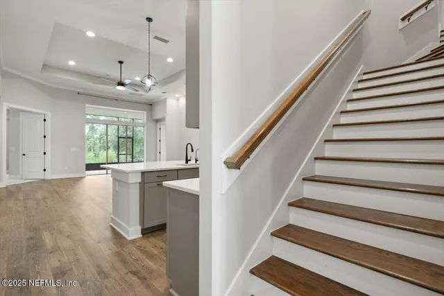 a living room with furniture and floor to ceiling windows