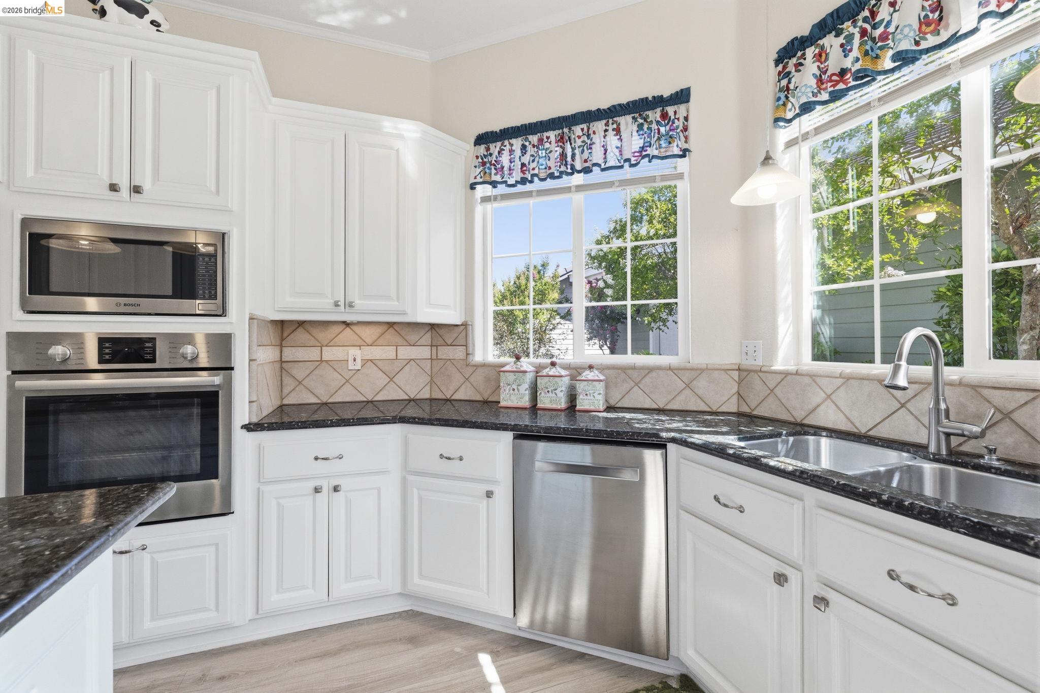 6242 Bluff View Road Copperopolis, CA 95228 - Photo 21 of 59 So much function in the kitchen! To the pull out shelves in the cabinets to the higher end Bosch appliances to the wrap-around cabinets and center island, this kitchen is perfect to lots of cooks and helpers