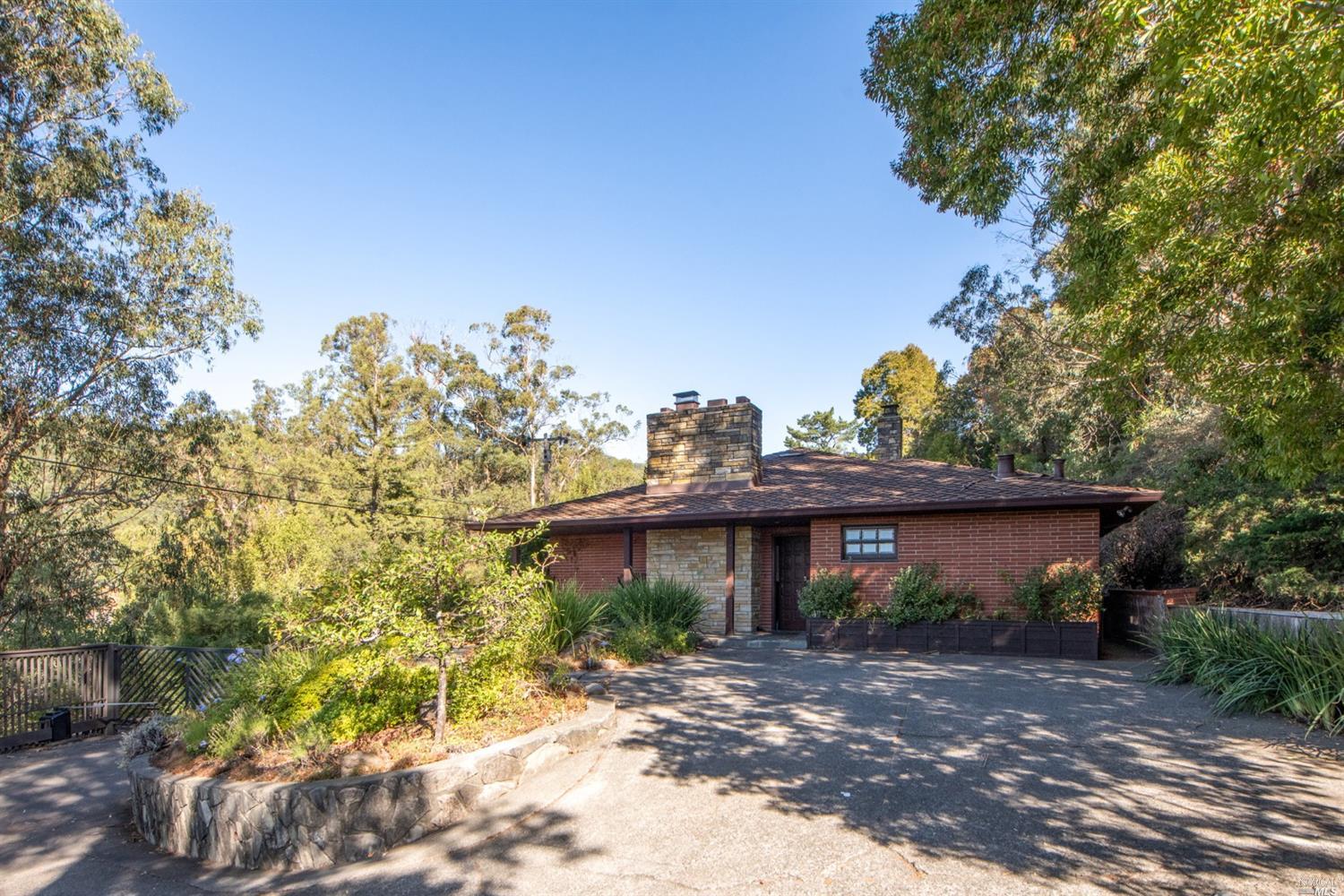 a view of a house with a tree and a yard