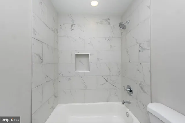 a bathroom with a bathtub and toilet