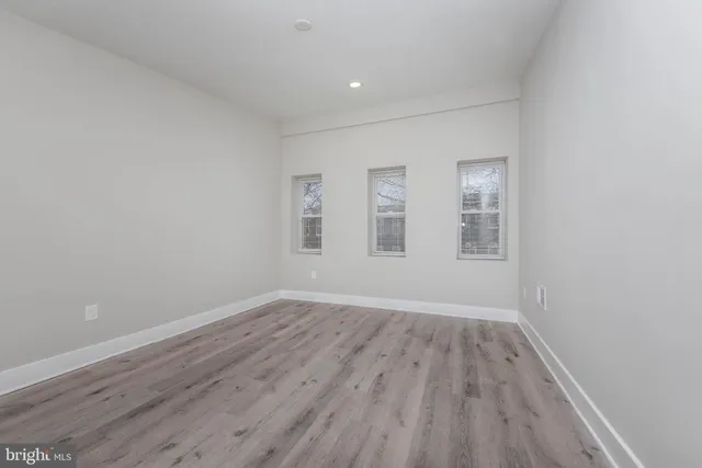 wooden floor in an empty room with windows