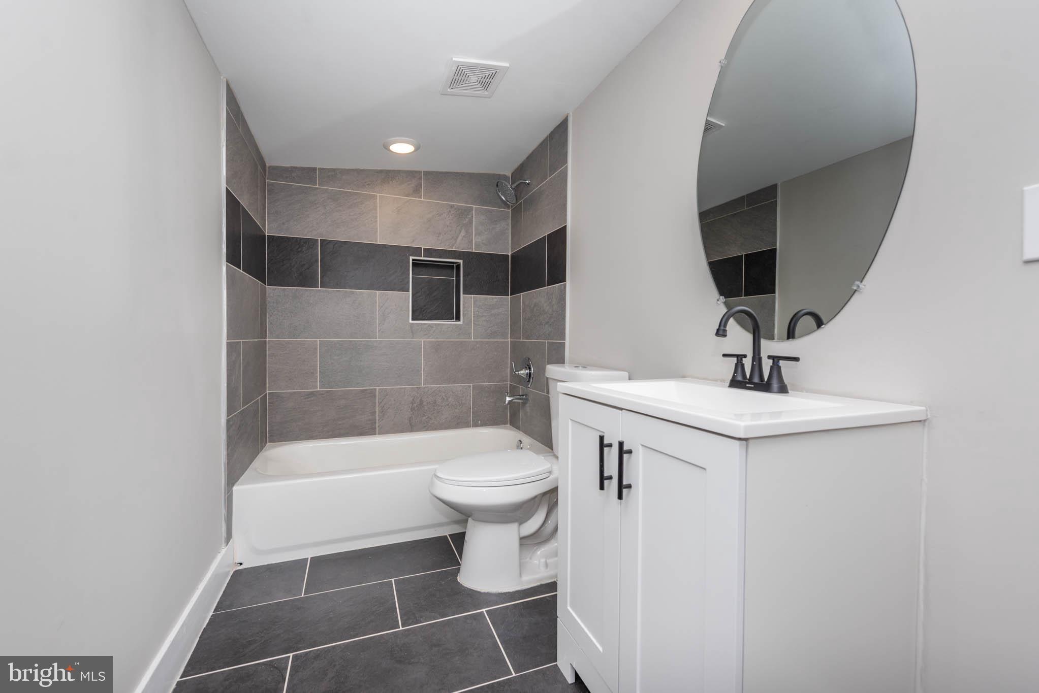 1011 North Mount Street Baltimore, MD 21217 - Photo 17 of 23 a bathroom with a sink a toilet and shower