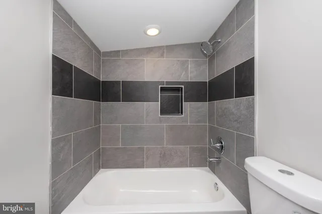 a bathroom with a bathtub and toilet