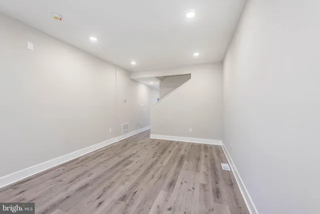 a view of room with wooden floor and fan