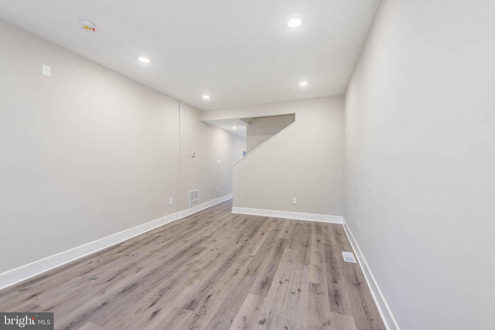 1011 North Mount Street Baltimore, MD 21217 - Photo 3 of 23 a view of room with wooden floor and fan