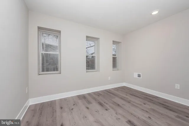 a view of a room with wooden floor and windows