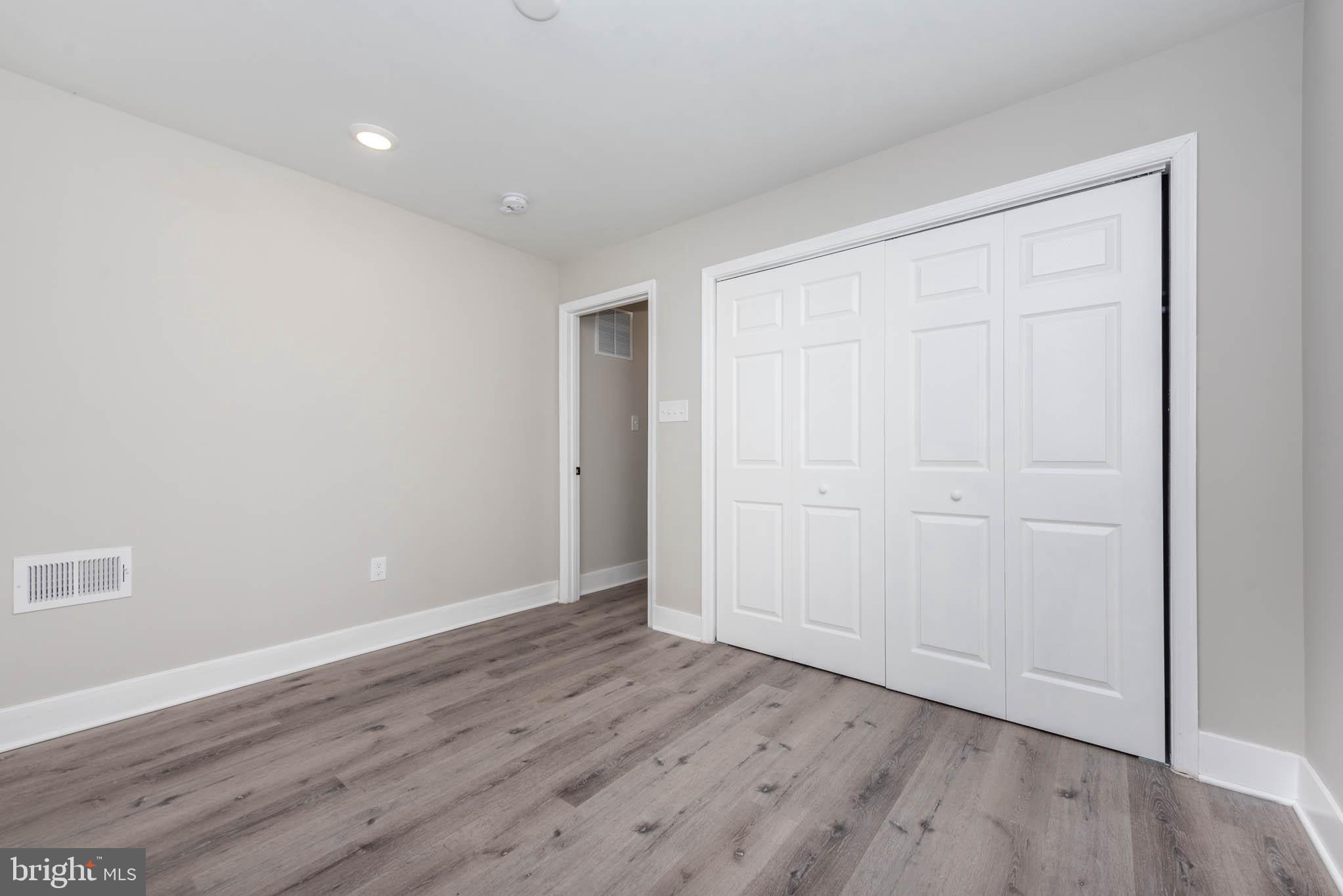1011 North Mount Street Baltimore, MD 21217 - Photo 10 of 23 a view of an empty room with wooden floor
