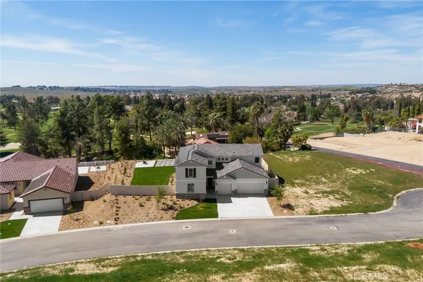 an aerial view of a house with a yard