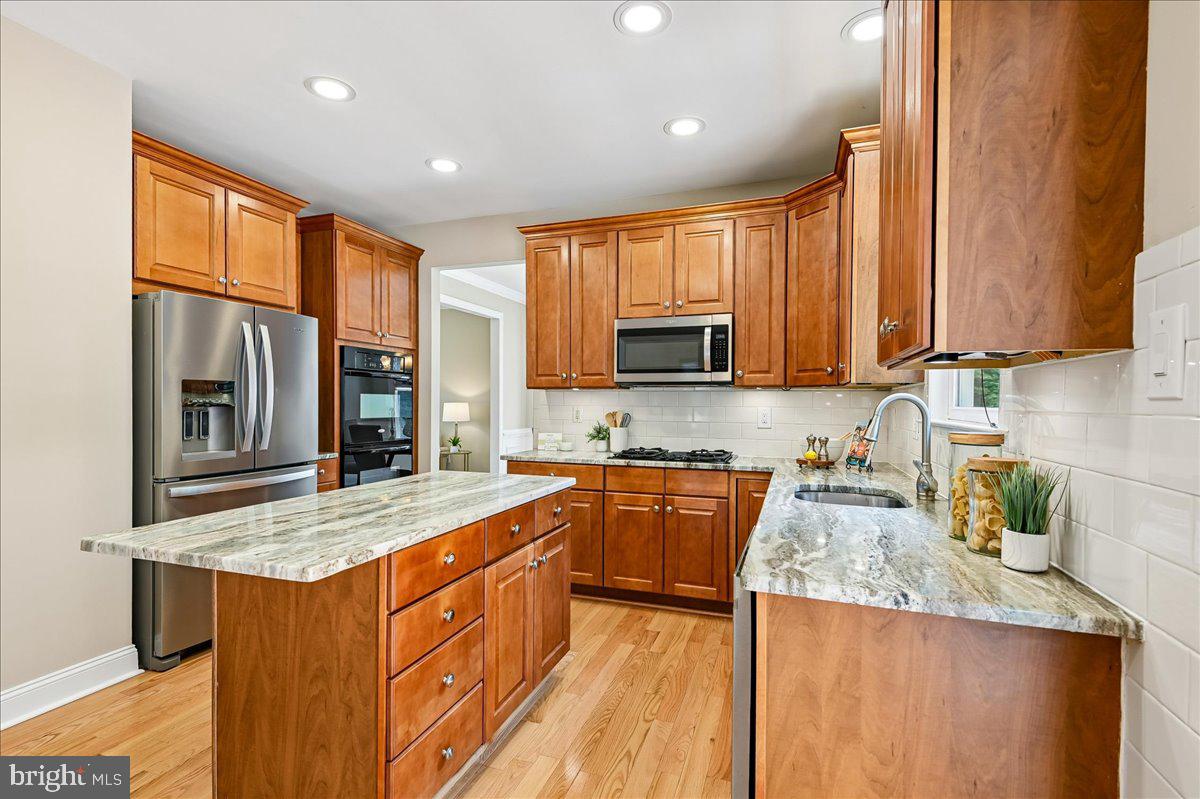 603 Queenstown Road Severn, MD 21144 - Photo 16 of 85 Modern kitchen with rich wood tones.