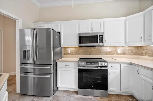 a kitchen with a sink window and cabinets