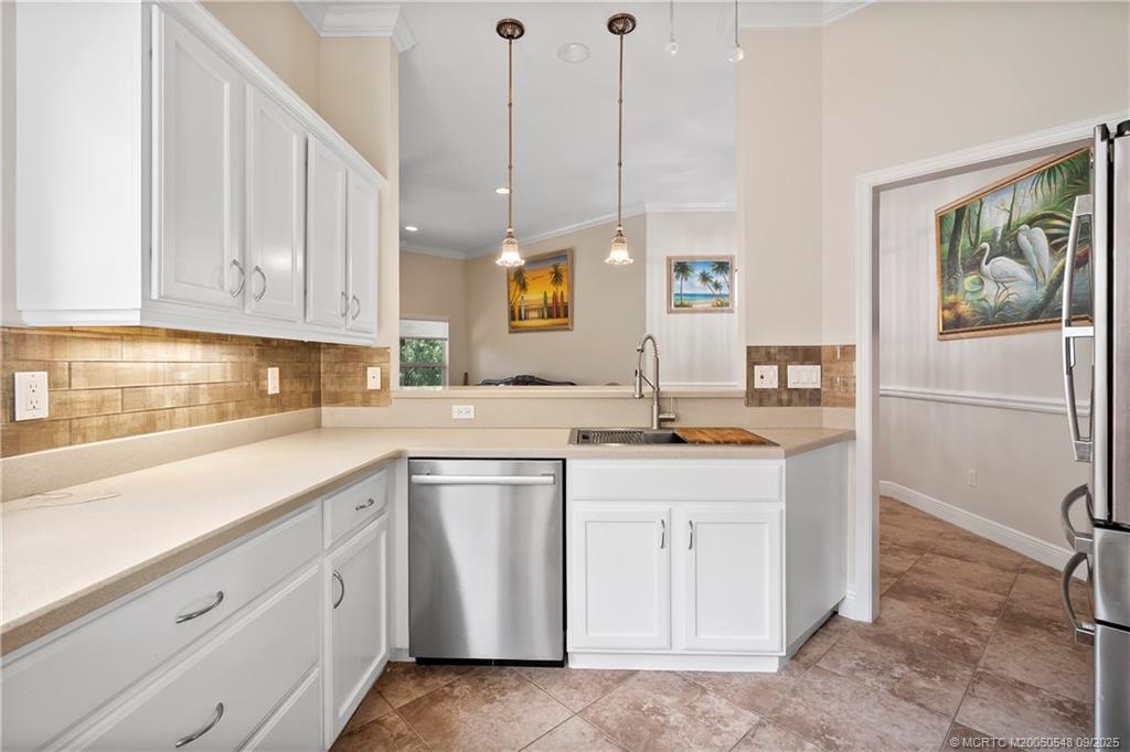 2194 Northwest Tilia Trail Stuart, FL 34994 - Photo 14 of 39 a kitchen with a sink window and cabinets