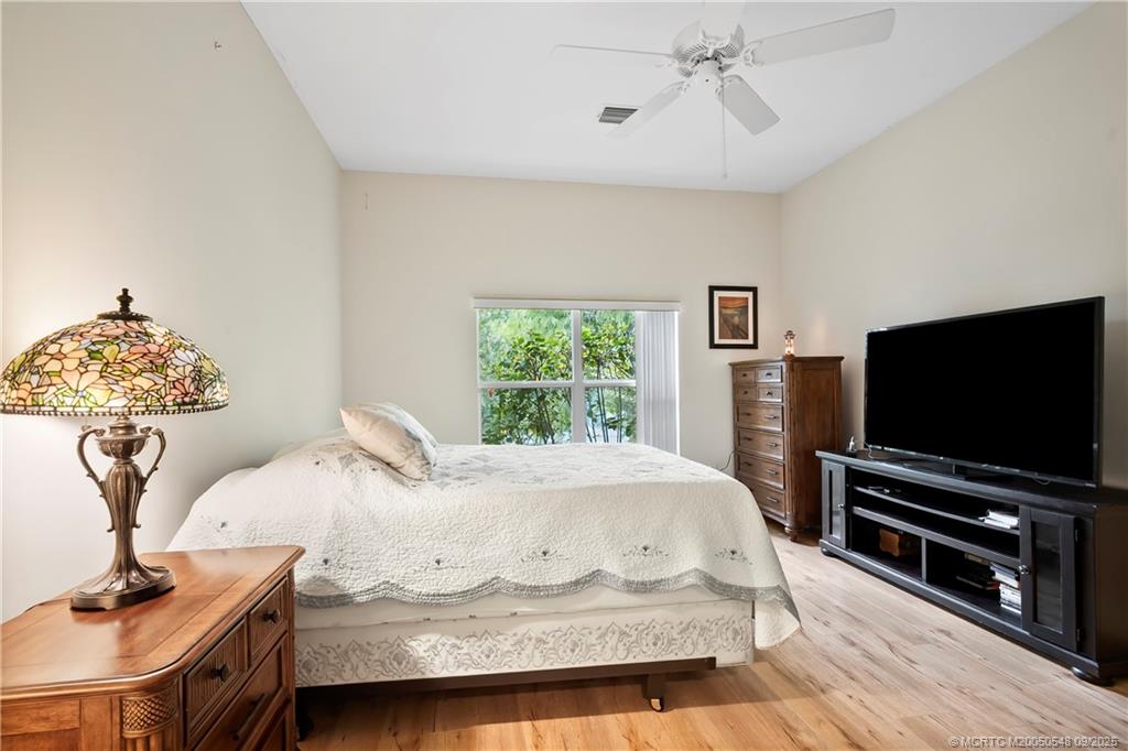 2194 Northwest Tilia Trail Stuart, FL 34994 - Photo 16 of 39 a bedroom with a bed and a flat screen tv