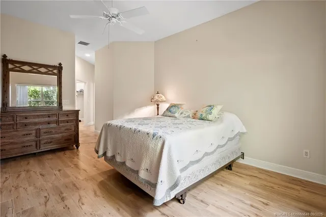 an empty room with a ceiling fan and carpet