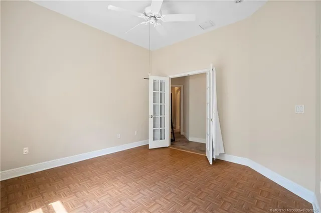 an aerial view of a house with a yard and large trees
