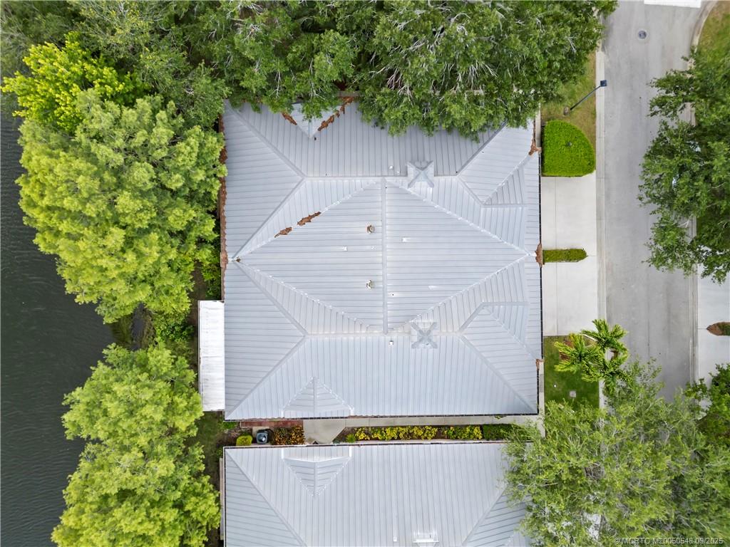 2194 Northwest Tilia Trail Stuart, FL 34994 - Photo 26 of 39 an aerial view of a house with a yard and large trees