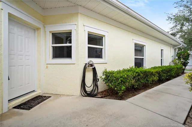 a view of a balcony with table and chairs and wooden floor
