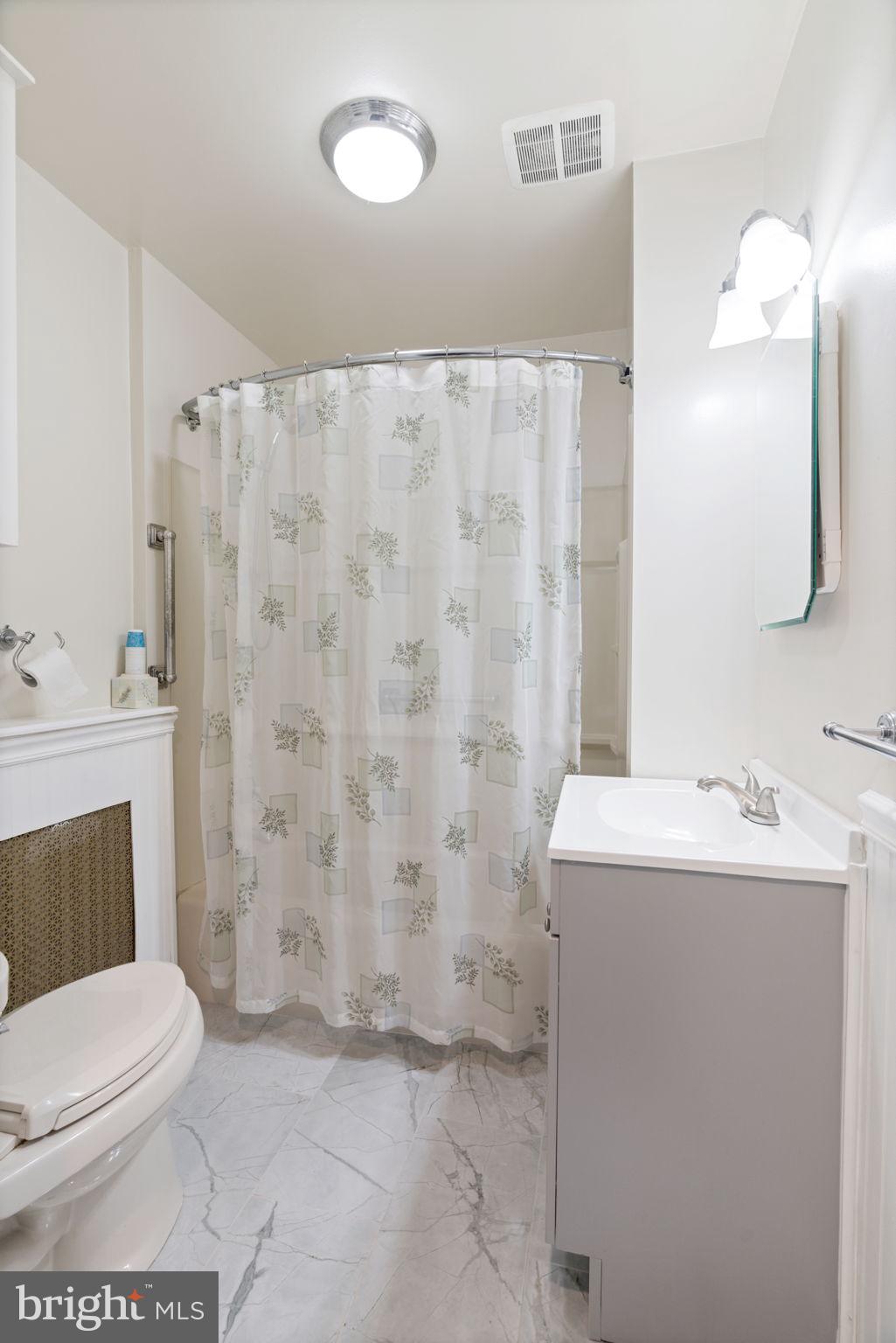 231 West Mill Road Maple Shade, NJ 08052 - Photo 39 of 59 a bathroom with a sink a toilet and shower curtain