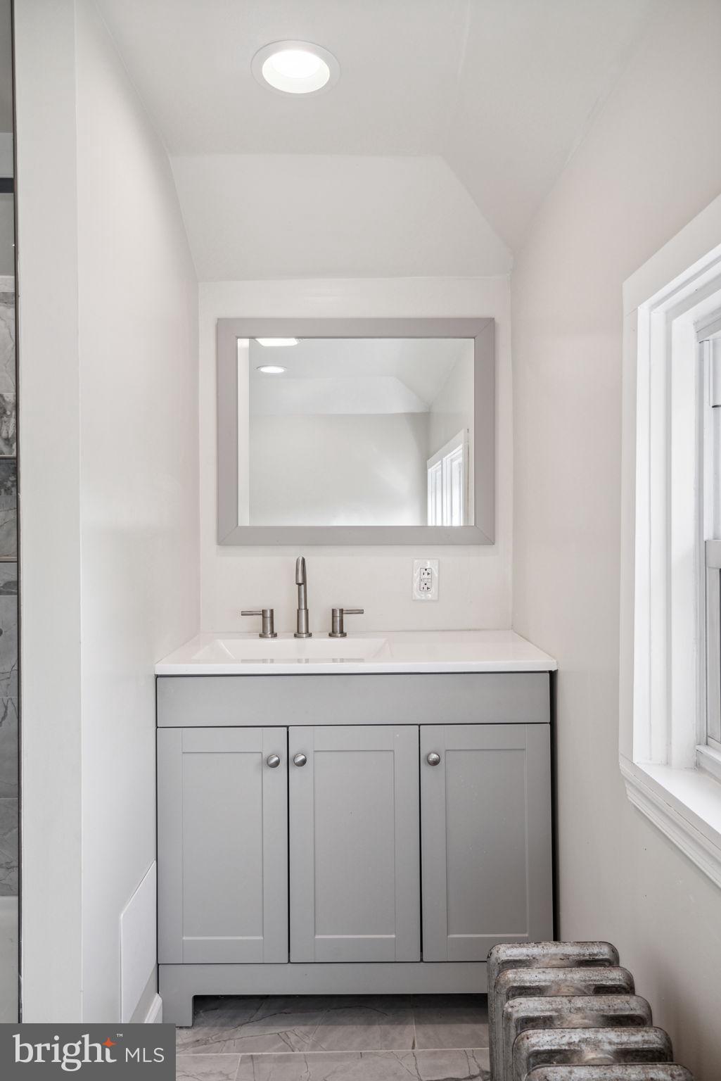 231 West Mill Road Maple Shade, NJ 08052 - Photo 50 of 59 a bathroom with a granite countertop sink a mirror and a window