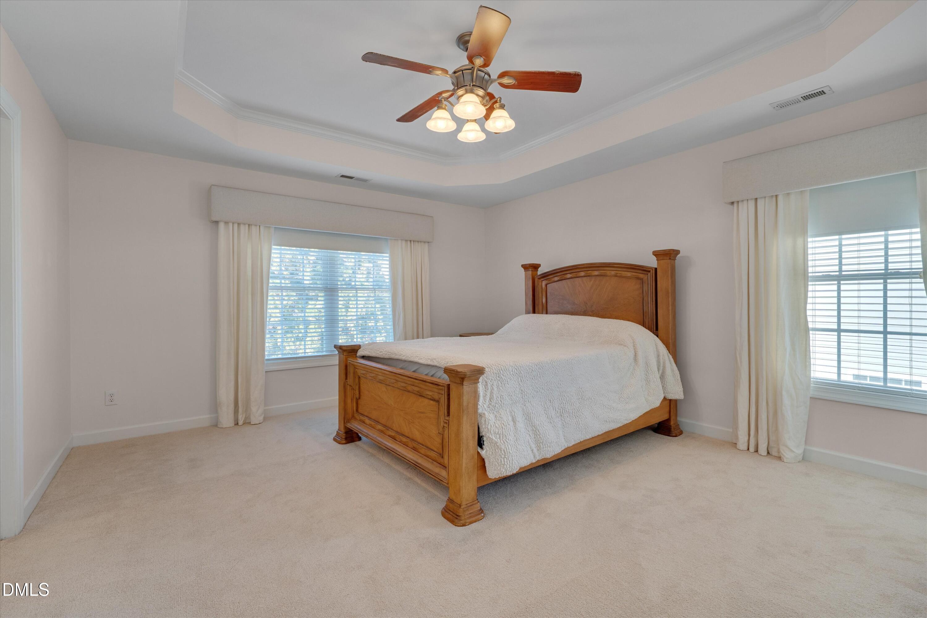112 Beckford Road Cary, NC 27518 - Photo 32 of 55 Primary Bedroom with tray ceiling and ceiling fan