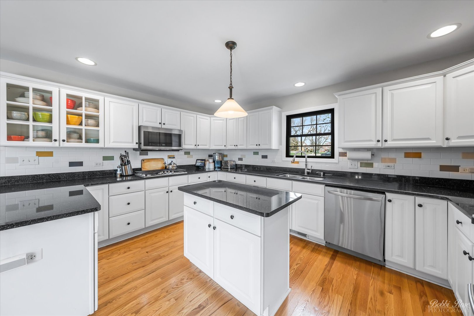 439 South Church Road Bensenville, IL 60106 - Photo 17 of 49 a kitchen with stainless steel appliances granite countertop a sink dishwasher a stove and white cabinets with wooden floor