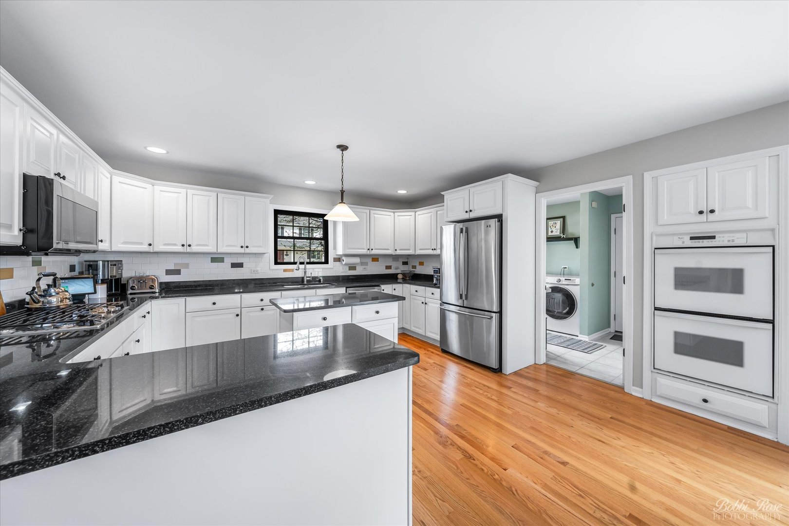 439 South Church Road Bensenville, IL 60106 - Photo 18 of 49 a large kitchen with granite countertop a large counter top stainless steel appliances and cabinets