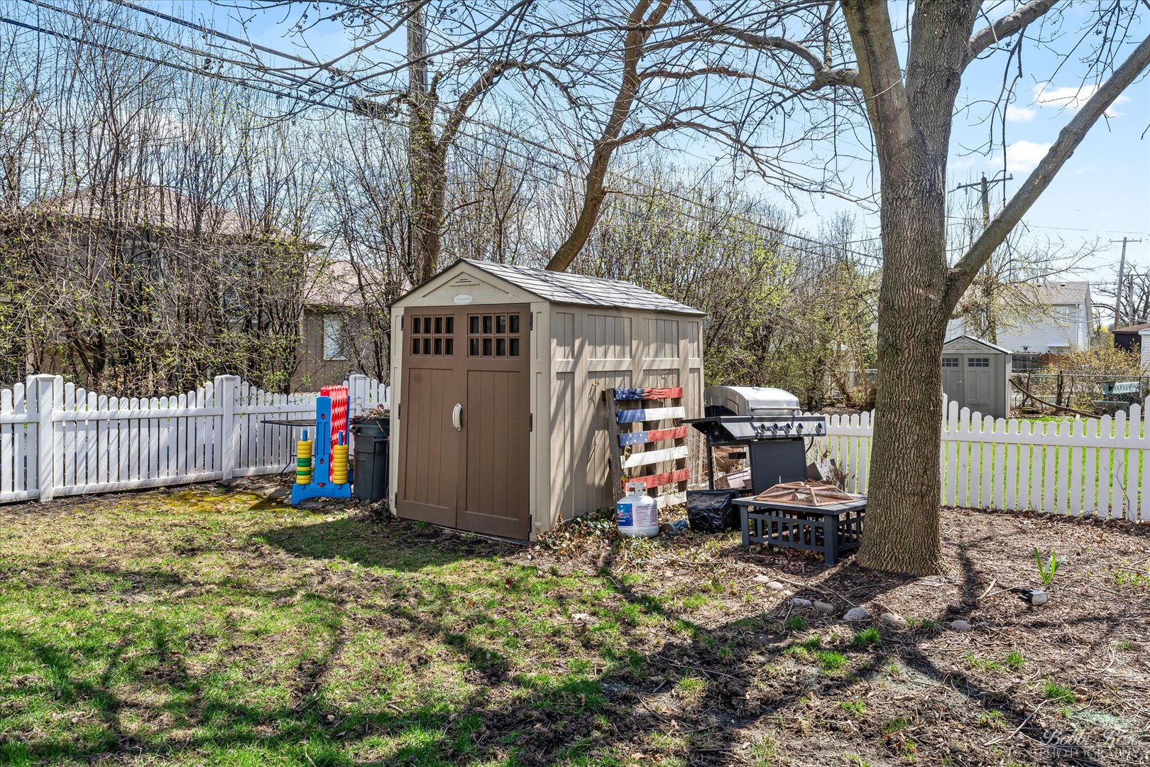 439 South Church Road Bensenville, IL 60106 - Photo 44 of 49 a view of a small yard in front of a house with wooden fence