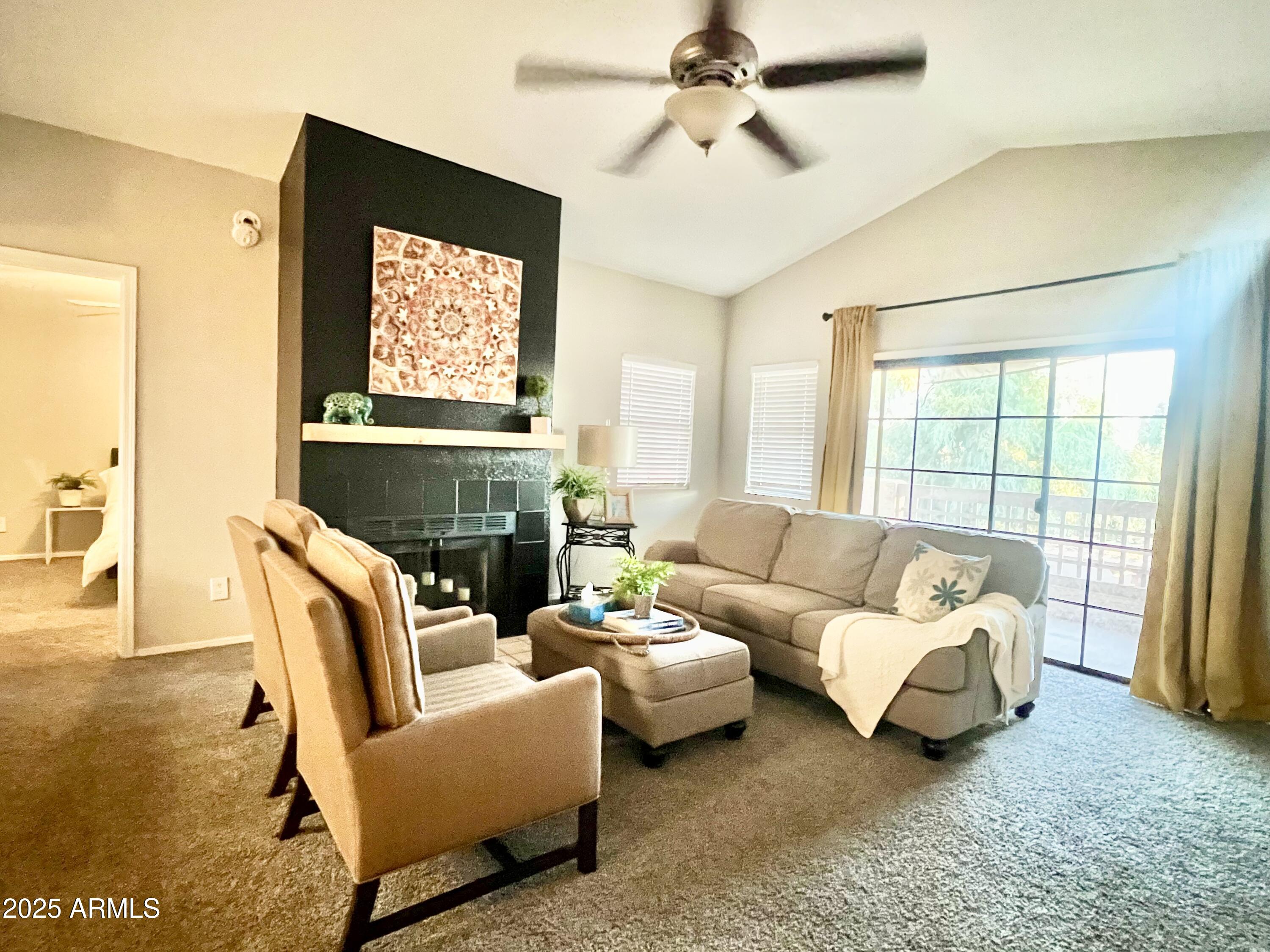 2855 South Ext Road, Unit 220 Mesa, AZ 85210 - Photo 1 of 40 a living room with furniture a flat screen tv and a large window