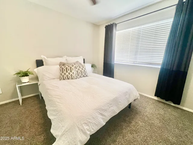 a bedroom with a bed and a window