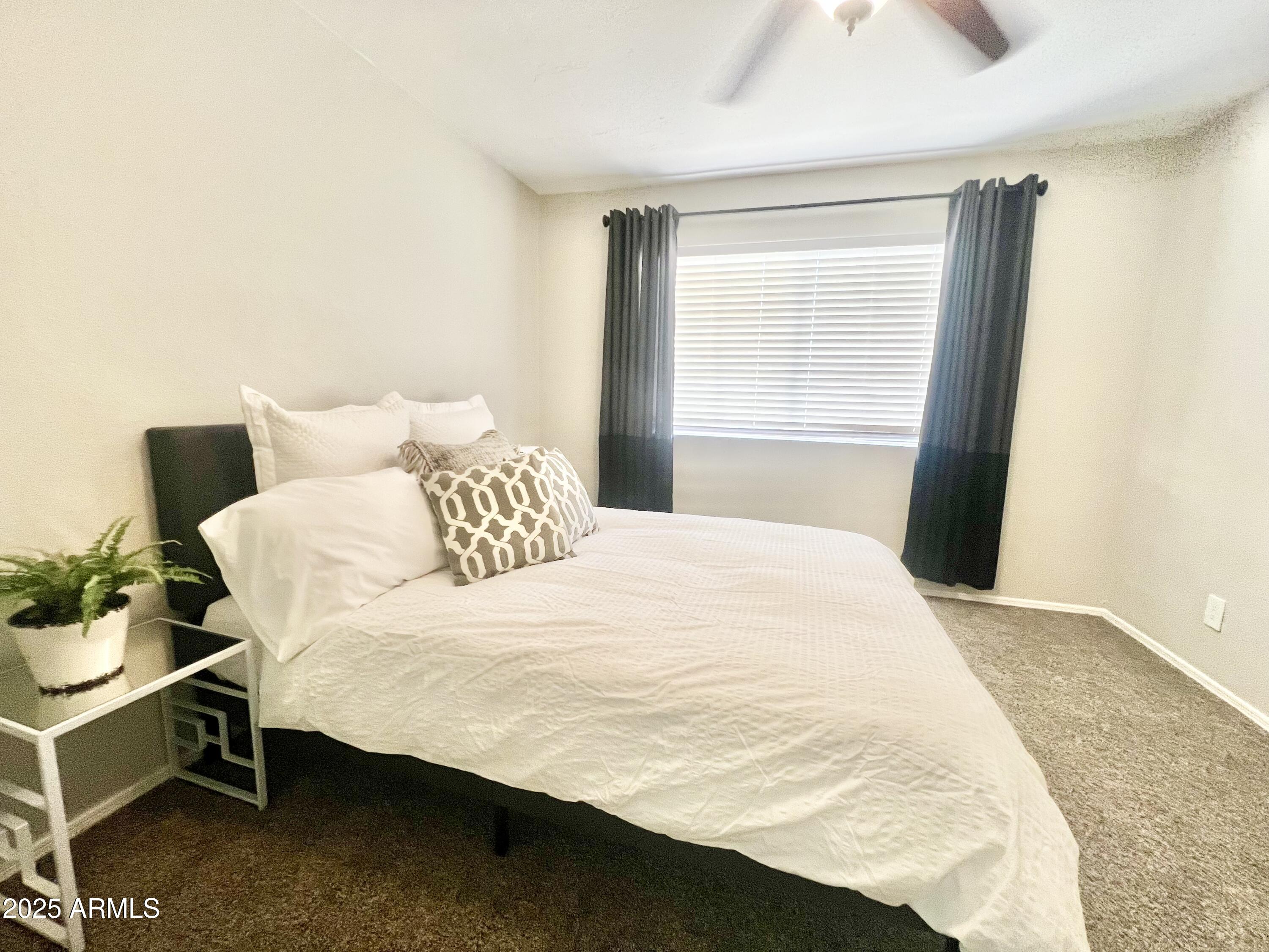 2855 South Ext Road, Unit 220 Mesa, AZ 85210 - Photo 17 of 40 a bedroom with a bed and window