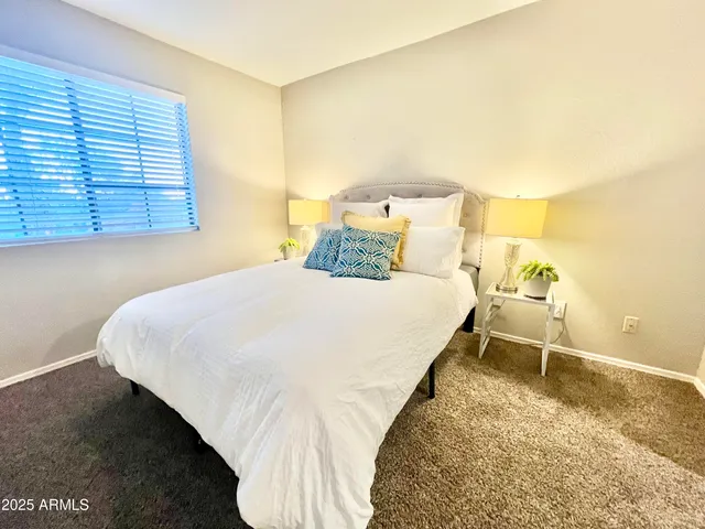 a bedroom with a bed and window