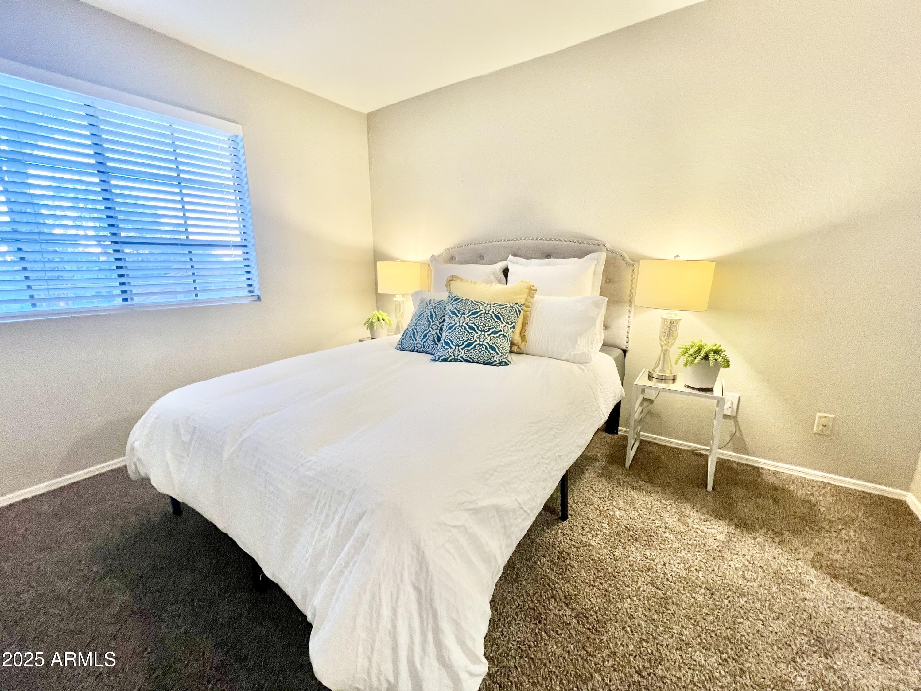 2855 South Ext Road, Unit 220 Mesa, AZ 85210 - Photo 21 of 40 a bedroom with a bed and window